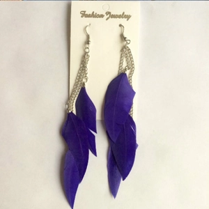 Long purple feather tassel earrings with silver chains on white display card