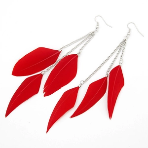 Close-up of long red feather tassel earrings with silver chains on white background