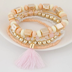 Bohemian multi-layer beaded bracelet set with pink tassels and gold accents