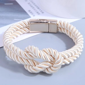 Handcrafted cream woven PU leather bracelet with a gold magnetic clasp and knot detail