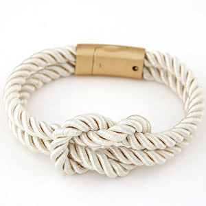 Detail of white nautical sailor knot braided PU leather bracelet with gold magnetic clasp