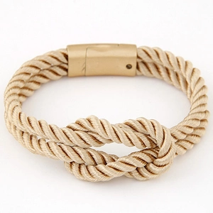 Close-up of a woven PU leather cord bracelet with a golden nautical knot and magnetic clasp