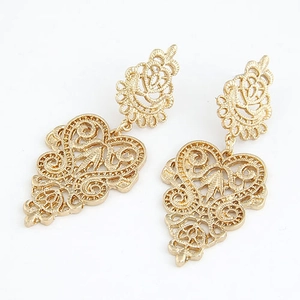 Vintage gold hollow floral drop earrings with intricate lace mesh pattern on white background