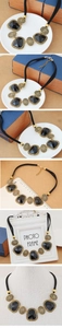 Detail of retro gold metal disc and black resin pendant on adjustable neck cord