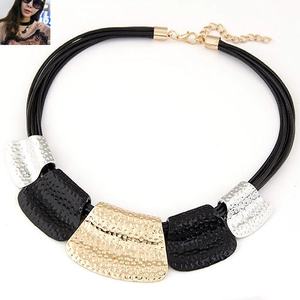 Detail of multi-strand cord necklace with hammered gold, silver and black metal plates
