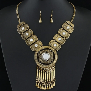 Vintage bohemian jewelry set with white gemstone necklace and teardrop earrings in gold