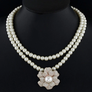 Double-layer pearl necklace with a vintage pink flower pendant on a black display stand