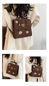 Detail of brown vintage backpack featuring cartoon embroidery and wrinkled texture
