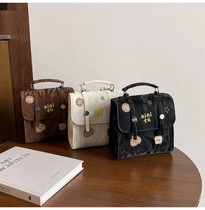 Detailed embroidery and vintage buckle on retro college style handbags in three colors