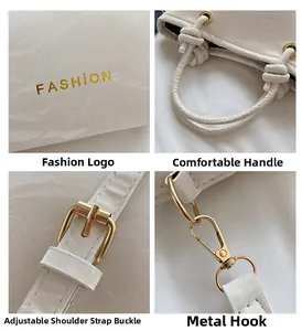 Detailed view of white leather bucket bag featuring gold hardware and fashion logo