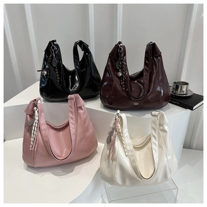 Polished faux leather hobo bags in four colors arranged on a minimalist white staircase