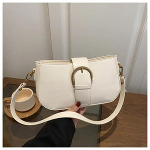 Détail du sac sous le bras minimaliste blanc avec boucle dorée et bandoulière en cuir