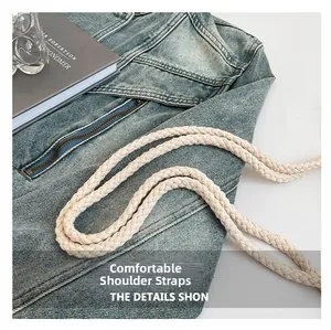 Detail of comfortable off-white woven shoulder strap on a stylish summer straw tote bag