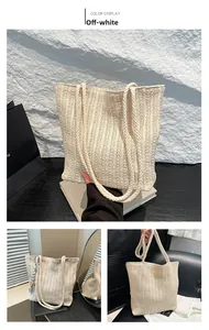 Macro shot of off-white straw woven tote bag showing vertical textures and rope handles