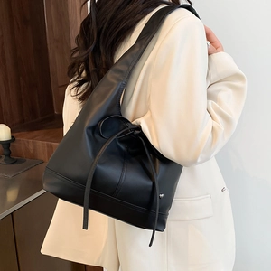 Minimalist black leather hobo tote bag with bow strap detail and large capacity