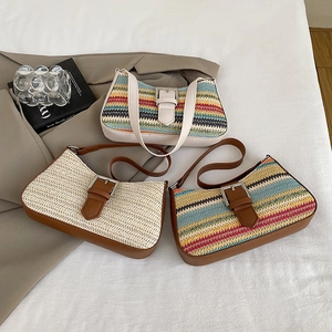 Fashionable woven straw shoulder bag for summer beach holidays featuring contrast stitching