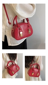 Detail of red PU leather bowling bag featuring golden buckles and adjustable strap