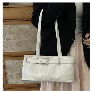 Detailed view of white oil wax leather shoulder bag with decorative belt buckle strap