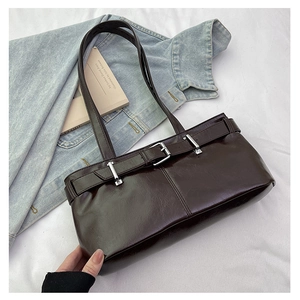 Detail of dark brown leather shoulder bag with silver buckle and belt-wrapped closure
