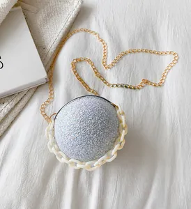 Detailed view of spherical evening bag with silver glitter finish and chic dual chains