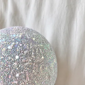 Macro detail of high-density hexagonal sequins with metallic luster on spherical bag
