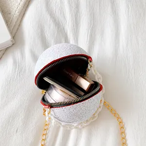 Detail view of spherical evening bag showing capacity for lipstick and shiny glitter texture