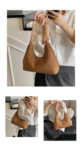 Close-up of brown woven texture hobo bag showing shoulder and hand-carry styles