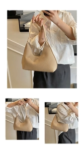 Detail of beige woven hobo bag with moon shape and top zipper for a minimalist chic look