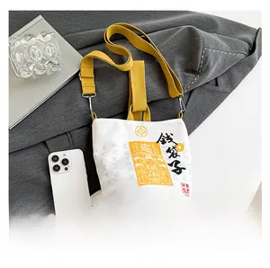 Detail of canvas bucket bag with Chinese lucky motifs and adjustable strap