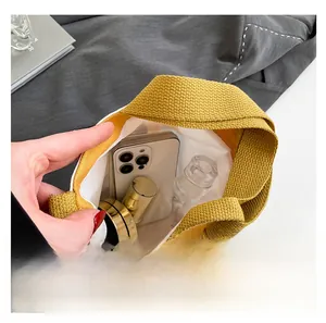 Top view showing the internal capacity of the mini canvas tote bag for phone and makeup