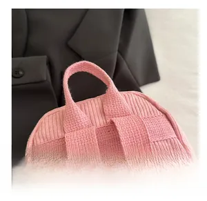 Detailed close-up of the comfortable pink corduroy backpack top handle and stitching