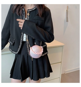 Detail view of pink glitter spherical evening bag with chic chain strap and handle