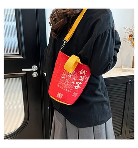Close-up of a red canvas money bag with yellow strap and Chinese calligraphy design