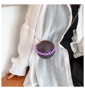 Detail of spherical evening bag with purple sequins and acrylic thick chain strap