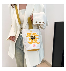 Detail of canvas bucket bag with lucky character print and adjustable shoulder straps