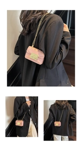 Lifestyle shot of a pink mini chain crossbody bag on a model wearing a black blazer