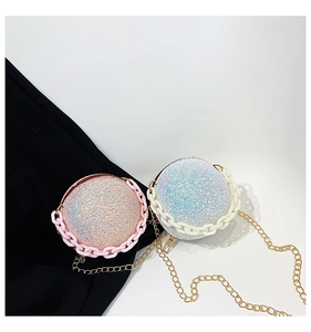 Detail of glitter spherical evening bag with metallic chain and sequined finish
