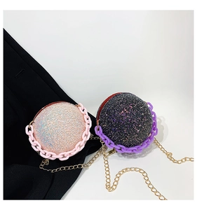 Close-up of glitter spherical bags in pink and black with colorful resin chain handles