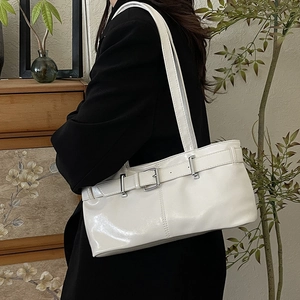 Glossy white faux leather shoulder bag with silver buckles and retro biker style details