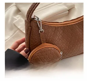 Close-up of brown woven texture shoulder bag with matching round coin purse detail