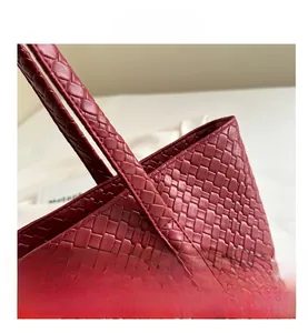 Detailed close-up of dark red crossbody woven leather pattern and premium craftsmanship