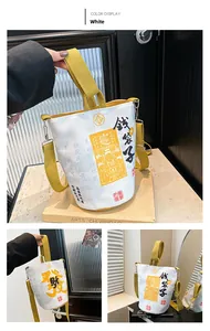 Detail of white canvas fortune bag with yellow straps and Chinese lucky typography