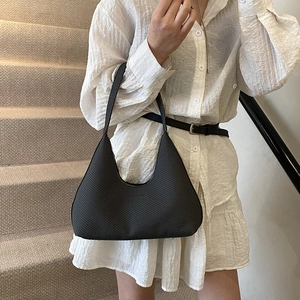 Minimalist black woven hobo shoulder bag with textured surface and elegant strap