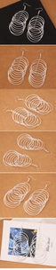 Detailed view of silver multi-layered hoop fringe earrings with a frosted texture finish