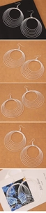 Detail of silver multi-layer hoop earrings with concentric rings and polished finish