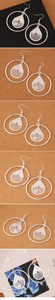 Macro view of silver geometric teardrop hoop earrings with layered hollow texture