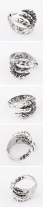 Macro detail of punk dragon claw open ring with vintage oxidized finish and textured surface
