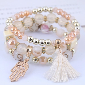 Multilayer beaded bracelet set with Hamsa hand charm, tassels, and champagne gold crystal beads