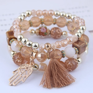 Bohemian multi-layer beaded bracelet with Fatima hand pendant and tassel in warm tones