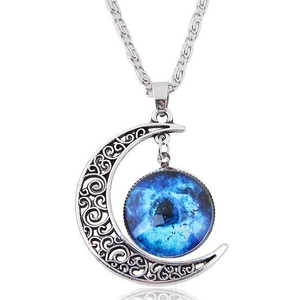 Detailed shot of hollow crescent moon pendant with blue galaxy glass stone on white background